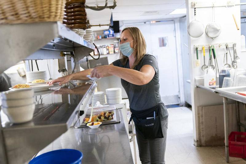 Server Michelle Miscinski works her lunch shift at the Cubby Cafe in Richmond on Wednesday. The restaurant is considering applying for a state grant of COVID-19 money for businesses in towns that have been disproportionately hit hard by the virus.