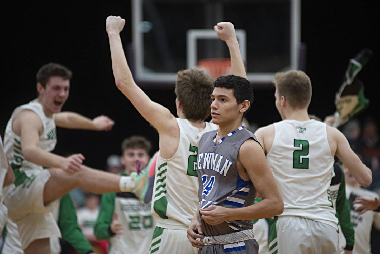 Newman's Alex Rico walks off the court as Scales Mound celebrates their sectional final victory 62-49 on Friday, March 4, 2022.