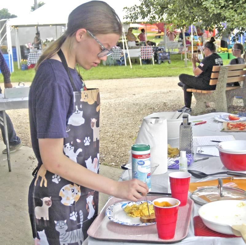 Jace Morgan of Dixon checks the temperature of her meal at the Culinary Creations Cook-off at the fair. Fair action at the Lee County Fair concluded with events Sunday, July 27, 2025.