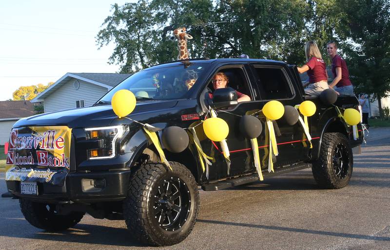 The staff of Granville National Bank rides a float during the inaugural Homecoming parade on Wednesday, Sept. 17, 2025 down Elm Street in Granville.