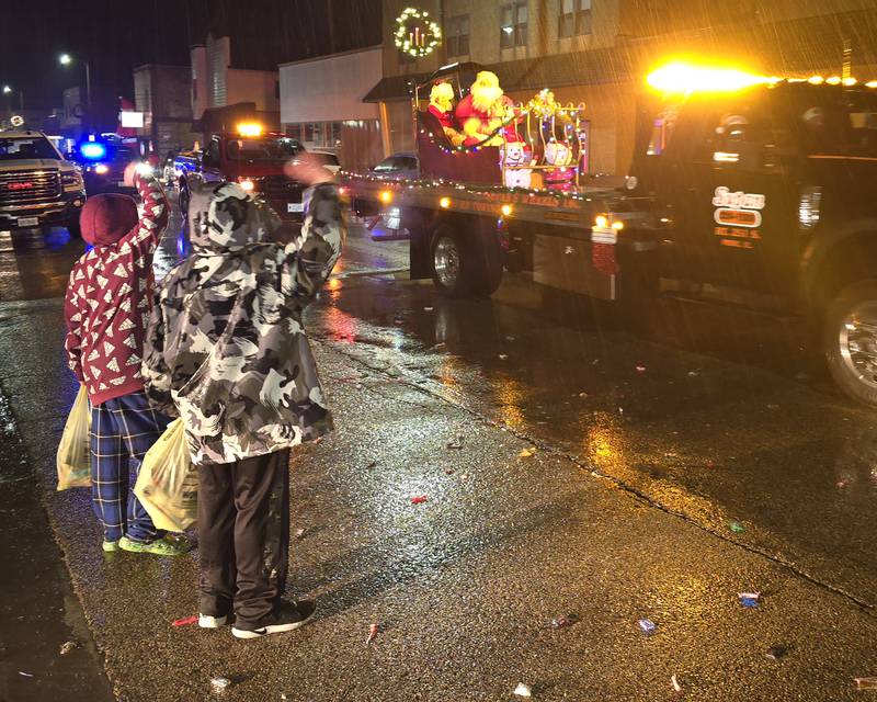 Children wave to Santa and Mrs. Claus on Saturday, Dec. 14, 2024, during the Winter Wonderland parade in Oglesby.