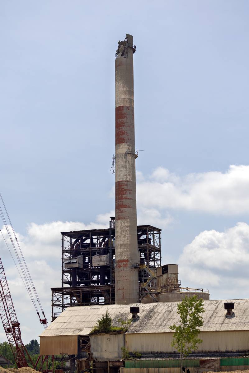 Work continues on demolishing the stubborn smokestack Tuesday, July 22, 2025, at the St. Mary’s  Cement plant in Dixon.