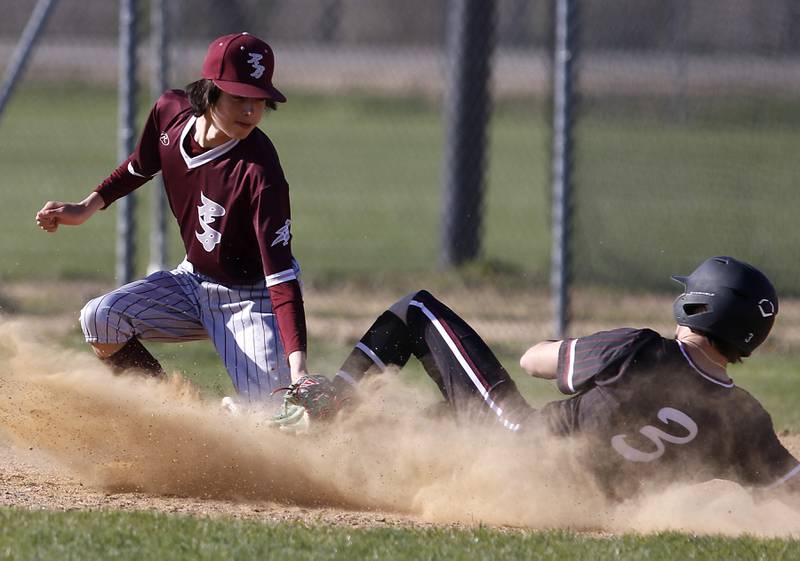 Richmond-Burton's Grayson Morningstar tags out Marengo's David Lopez as he slides into third base during a Kishwaukee River Conference baseball game on Thursday, April 25, 2024, at Marengo High School.