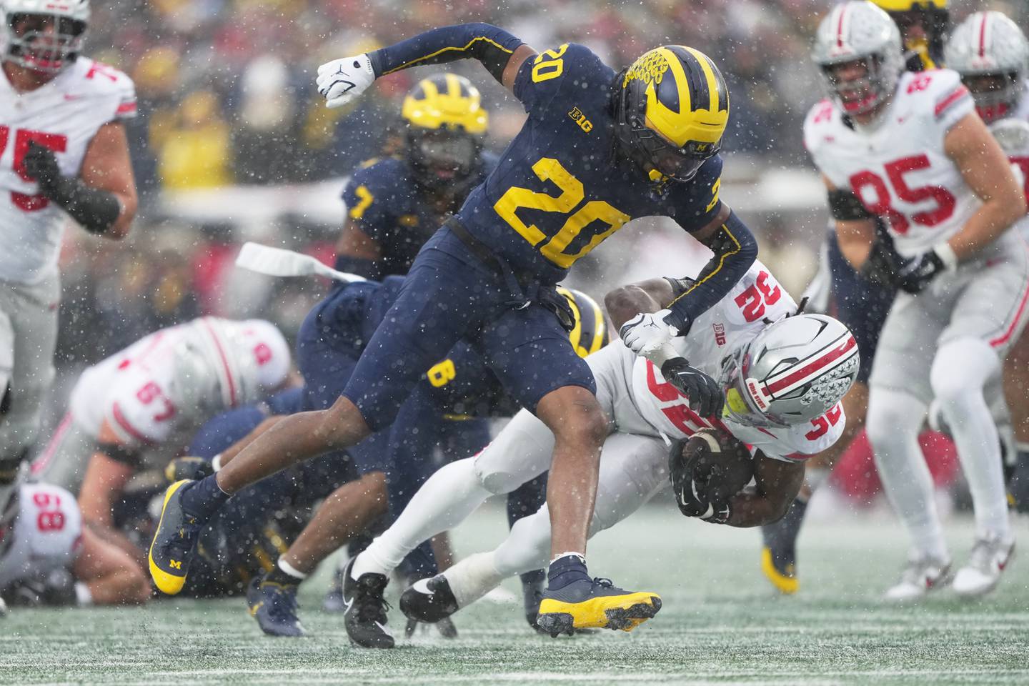 Michigan defensive back Jyaire Hill, left, tackles Ohio State running back Isaiah West during the second half of an NCAA college football game, Saturday, Nov. 29, 2025, in Ann Arbor, Mich. (AP Photo/Ryan Sun)
