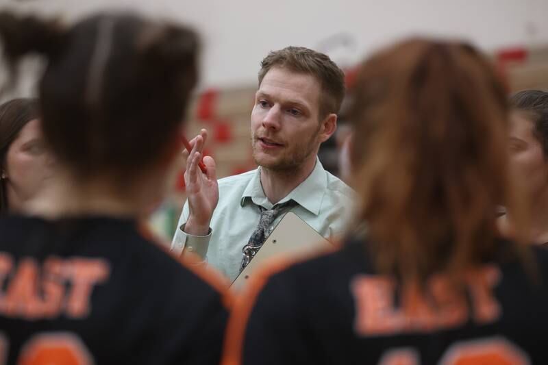 Plainfield East’s Kurt Dolson talks with his team between sets against Plainfield North on Thursday night.