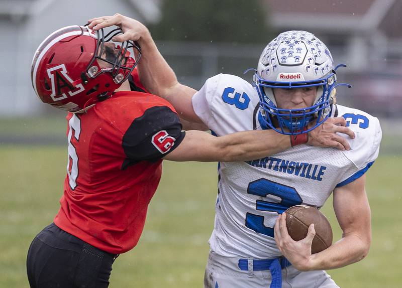 Martinsville’s Adam Parcel runs against Amboy’s Ed Fry Saturday, Nov. 9, 2024, in round two of the 8-man football playoffs.