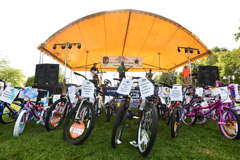 Donated bikes line the front of the stage as a band plays ahead of giveaways during the 2021 National Night Out at Perry Farm Park.
