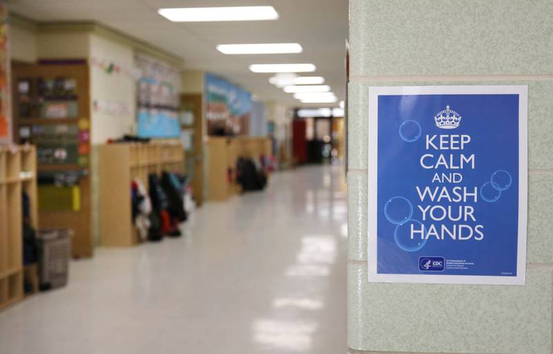 A sign in the hallway at Littlejohn Elementary School in DeKalb reminds students to wash their hands.