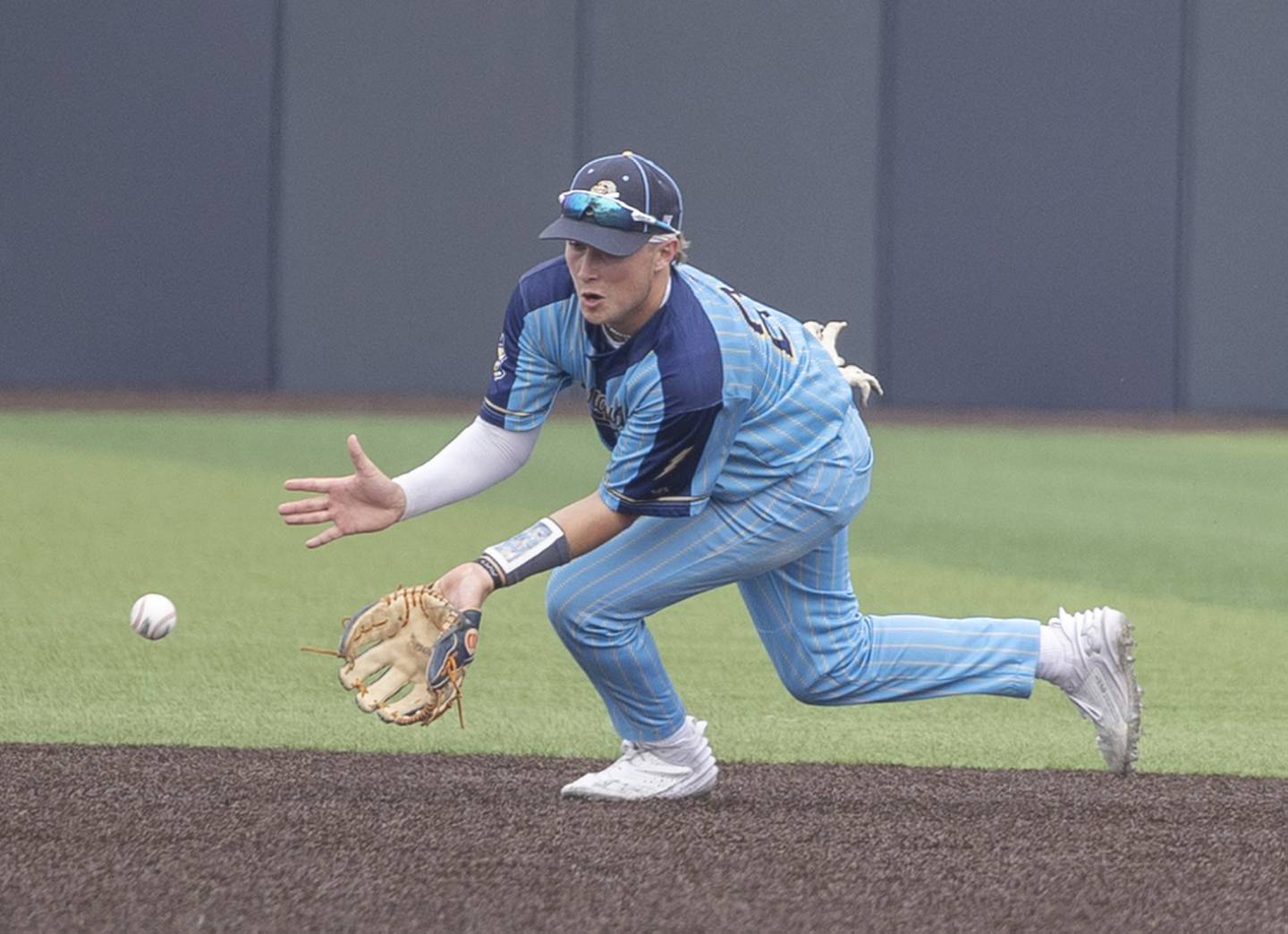 Ottawa Marquette’s Anthony Couch fields a ball against Father McGivney Saturday, June 7, 2025, during the Class 1A state baseball final at Illinois Field in Champaign.