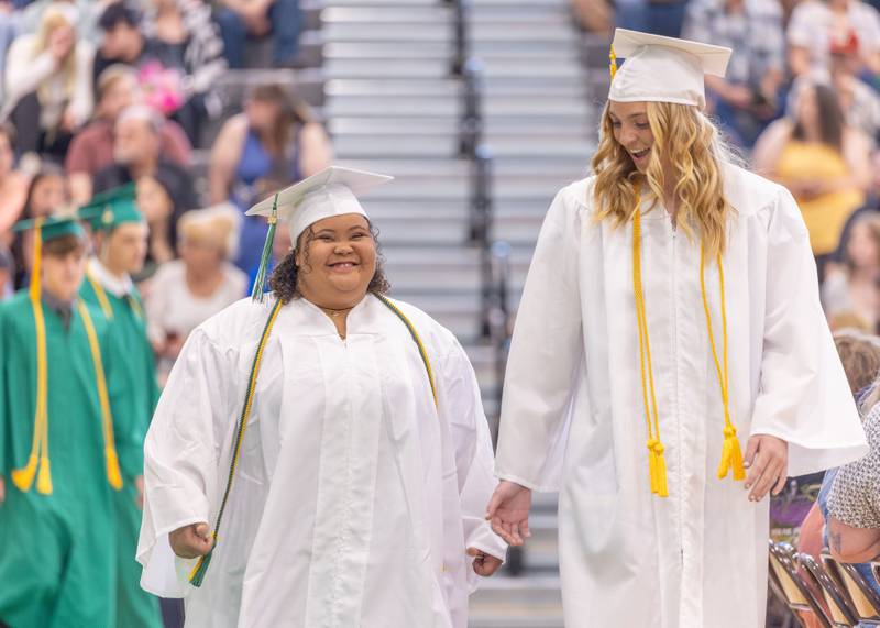 Cianna Honn and Tessa Krull walk into the auditorium for the ceremony at the Seneca High School Class of 2026 Graduation on May 17, 2026 at Seneca High School.