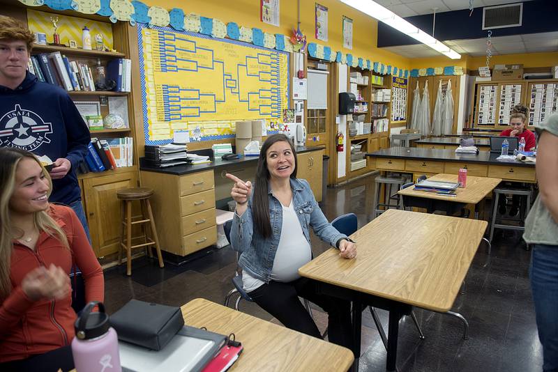 Schlemmer talks with some of her students who stop by to take lunch in her classroom.