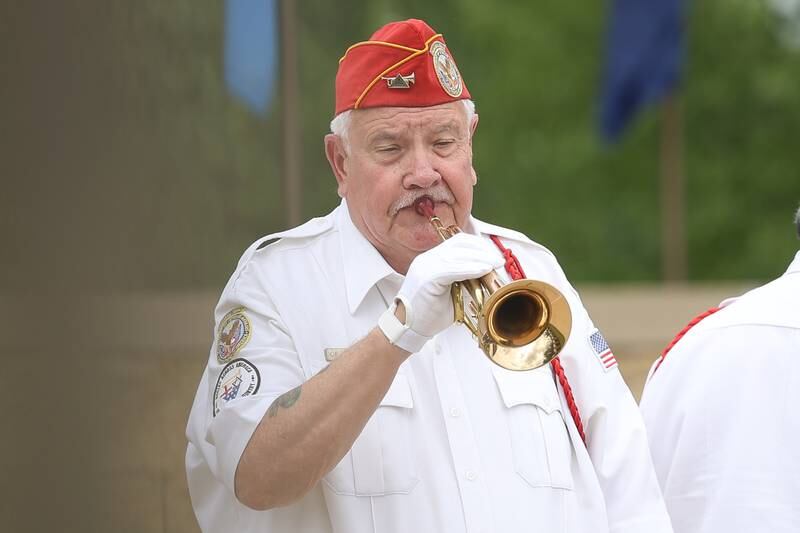 A member of the ALNC Memorial Squad Buglers performs Taps at the National Cemetery Administration 50th Anniversary ceremony at the Abraham Lincoln National Cemetery in Elwood on Saturday, July 29.