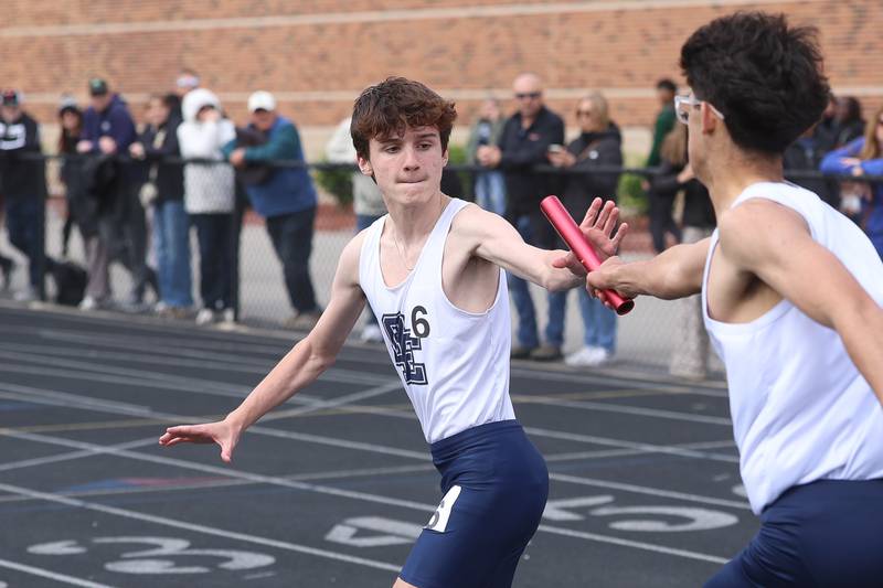 Oswego East’s Jack Wostenhom takes the baton in the final leg of the 4x800 Meter Relay in the Southwest Prairie Conference boys track and field championship on Wednesday, May 13, 2026 at Joliet West High School.