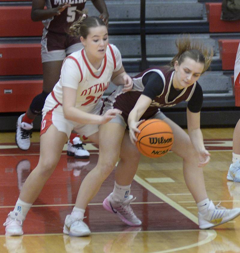 Ottawa’s Hailey Thrush attempts to steal the ball away from Moline’s Adalynn Voss in the 1st period Tuesday at Ottawa.