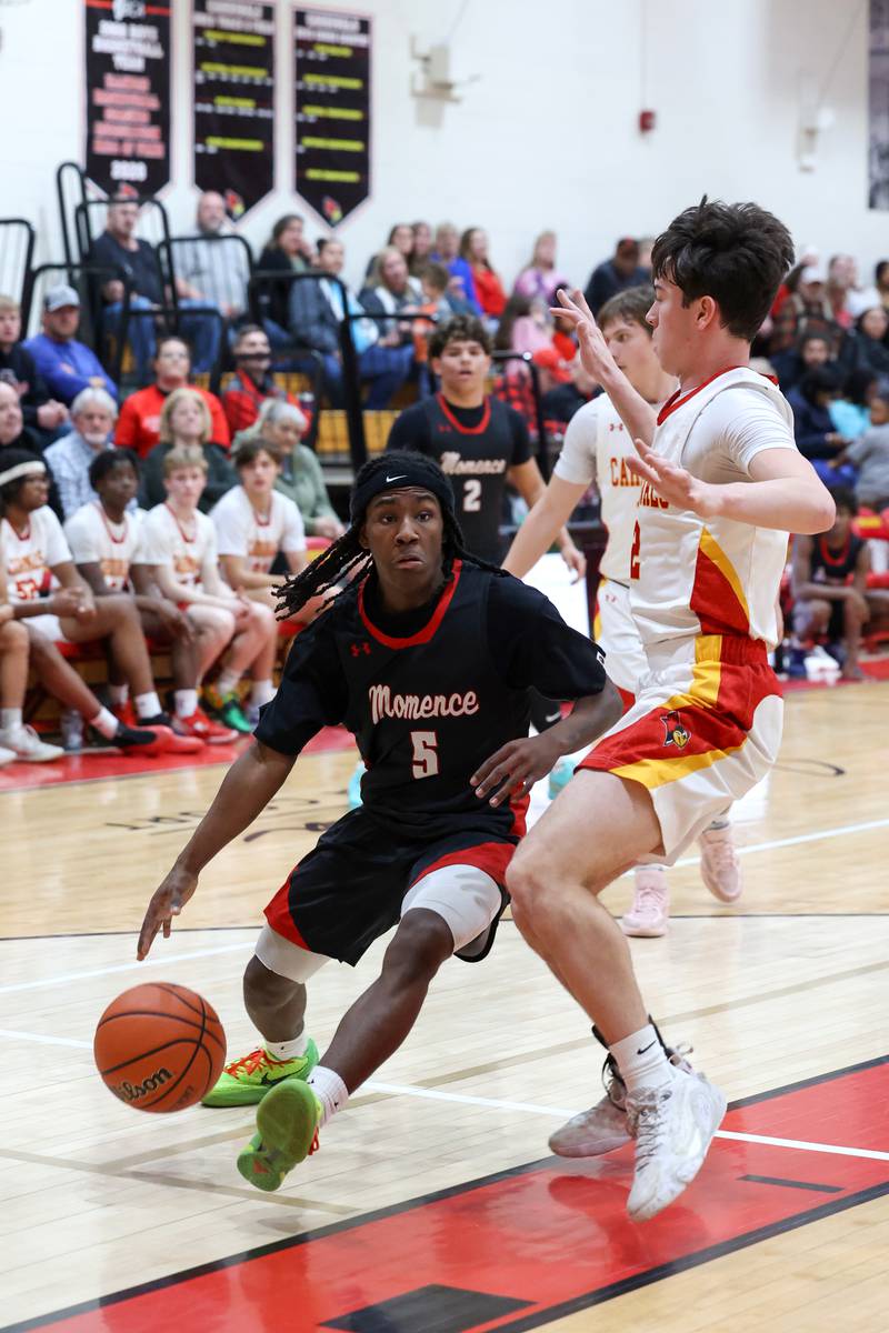 Momence's Aiden Smith drives to the basket against St. Anne's Matthew Langellier during St. Anne's 64-43 victory in the River Valley Conference semifinals on Tuesday, Feb. 10, 2026.