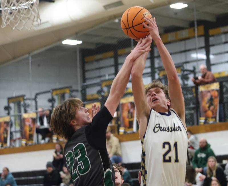 Midland's Dominic Rosa fouls Marquette's Lucas Craig during the Tri-County Conference Tournament on Monday, Jan. 26, 2026 at Putnam County High School