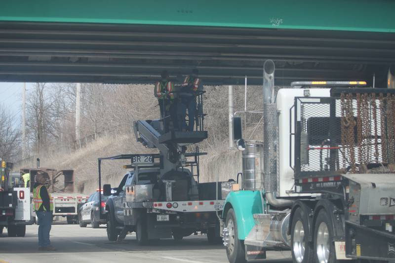 Illinois Department of Transportation crews inspect the 7th Street bridge over Illinois Route 251 after a semi struck it on Monday, March 10, 2025 in Peru. The semi was hauling two clamshell buckets for excavating equipment.