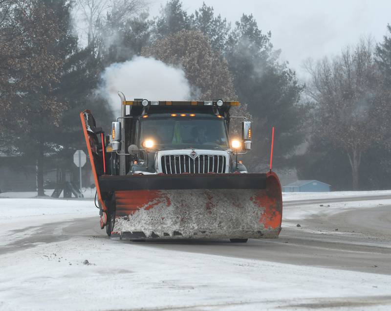 An Ogle County snow plow heads south on Illinois 2 late Friday afternoon after working to clear roads across the county on Friday. High winds and blowing snow made some county and township roads impassable prompting officials to strongly advise motorists not to venture out during the winter storm warning.