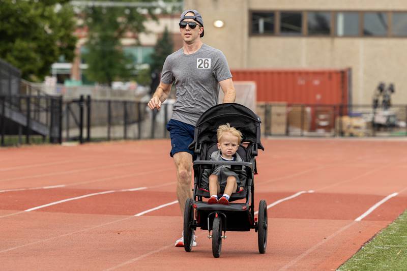 Cody Boender and his son race in the Ben’s Memorial Mile, a community festival held every summer to raise money and awareness for mental health and suicide prevention in honor of Ben Silver, on Saturday, July 22, 2023.