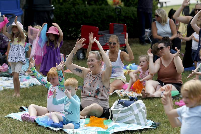 Children and family members enjoy the music of the Being Bilingual Rocks (BBR) Band during the Crystal Lake Park District and Public Library's Summer Singalong for Kids on Friday, June 21, 2024, at Crystal Lake's Main Beach.