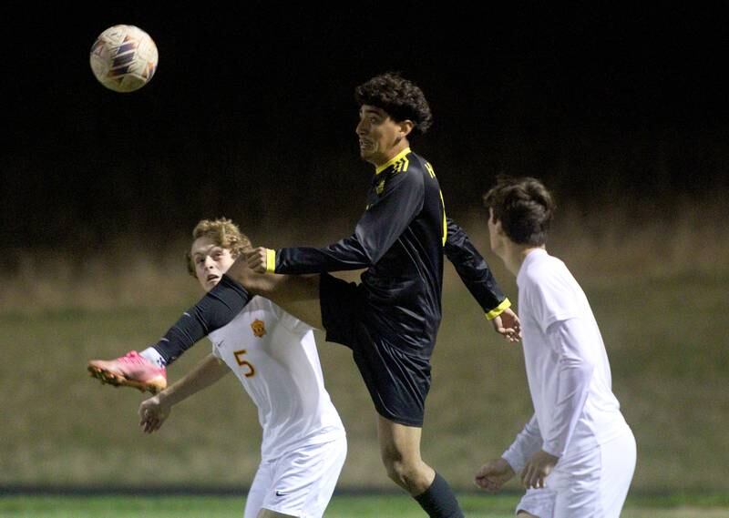 Harvard’s Miguel Mercado, center, battles Richmond-Burton’s Nate Larson, left, in varsity soccer on Monday, Oct. 7, 2024, at Dan Horne Field on the campus of Harvard High School in Harvard.