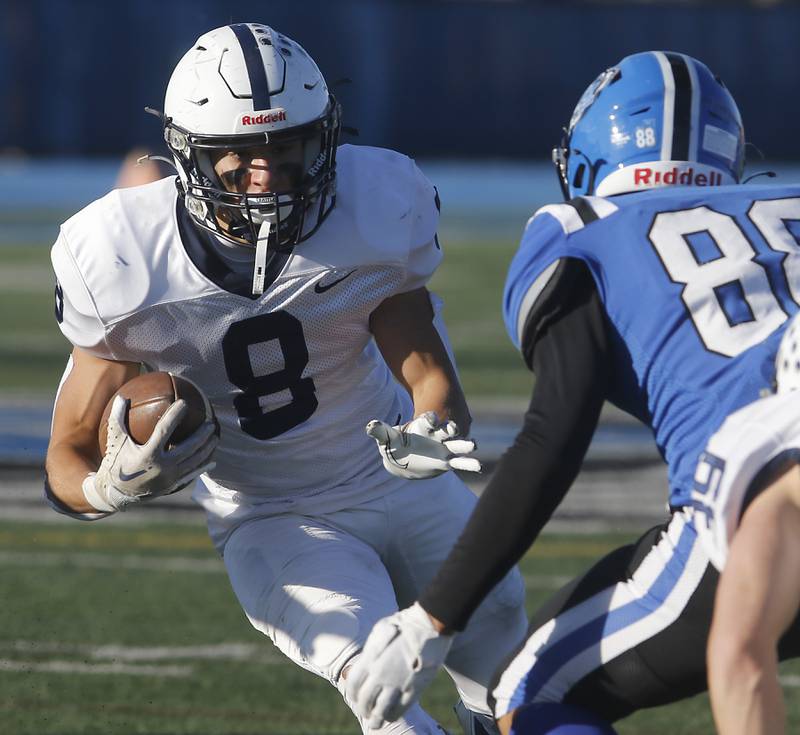 Cary-Grove's Andrew Prio tries to avoid Lake Zurich's Christopher Chang during a IHSA Class 6A semifinal playoff football game on Saturday, Nov. 18, 2023, at Lake Zurich High School.