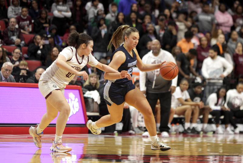 Nazareth Academy's Olivia Austin (right) keeps the ball away from Peoria's Denali Craig Edwards (left) during the Class 3A girls basketball state semifinal at Redbird Arena in Normal on Friday, March 3, 2023.