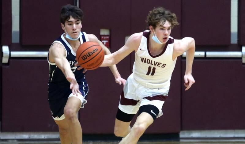 Prairie Ridge’s James Muse, right, moves the ball as Cary-Grove’s John Mau looks for a steal during boys varsity basketball action in Crystal Lake Tuesday night.