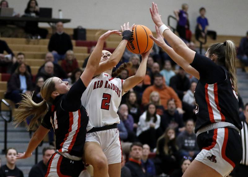Huntley's Avery Seuss drives to the basket between Libertyville's Sophia Cesnovar (left) and Libertyville's Madison Sears during the IHSA Class 4A Huntley Sectional Championship girls basketball game on Thursday, Feb. 27, 2025, at Huntley High School.