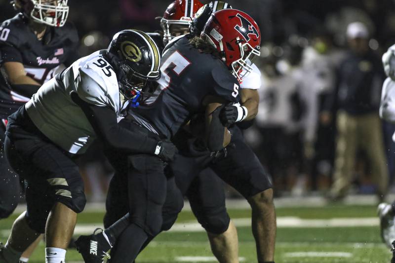 Glenbard North's Miguel Magana (95) and Xavier Smiley (11) tackle Yorkville's T.J. Harland (5) during Class 7A first round football game between Glenbard North at Yorkville. Friday, Oct 31, 2025 in Yorkville