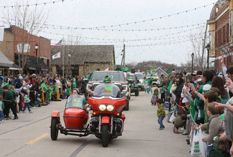 Confetti falls along Mill Street during the St. Patrick's Day parade on Saturday, March 15, 2025 downtown Utica.