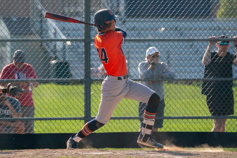 Oswego’s Trey Hernandez (14) singles against Oswego East during a baseball game at Oswego East High School on Wednesday, May 10, 2023.