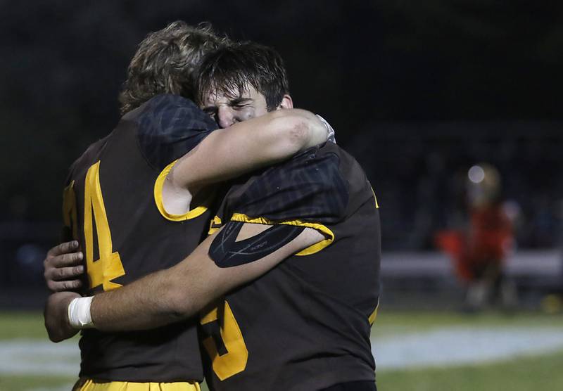 Jacobs' Dino Hunt, left, hugs his teammate, Kyle Kozielafter after Jacobs lost to Brother Rice in a IHSA Class 7A first round playoff football game Friday, Oct. 28, 2022, at Jacobs High School in Algonquin.