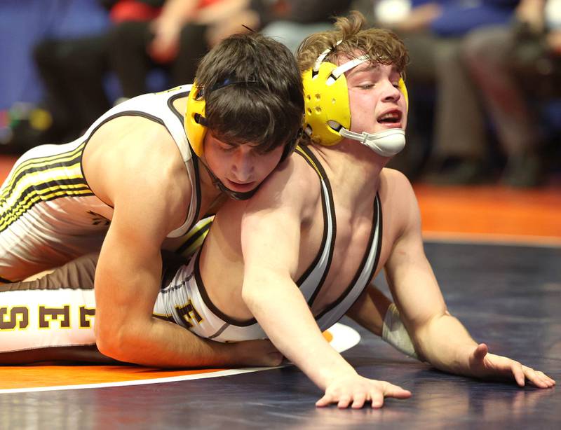 Glenbard North’s Mikey Dibenedetto Jr. (top) works to turn James Wright during the Class 3A 132 pound 5th place match in the IHSA individual state wrestling finals in the State Farm Center at the University of Illinois in Champaign.