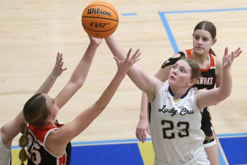 Marquette's Kelsey Cuchra tips the ball away from Roanoke-Benson's Callie Kennell on Thursday, Feb. 6, 2025 in Bader Gym at Marquette High School.