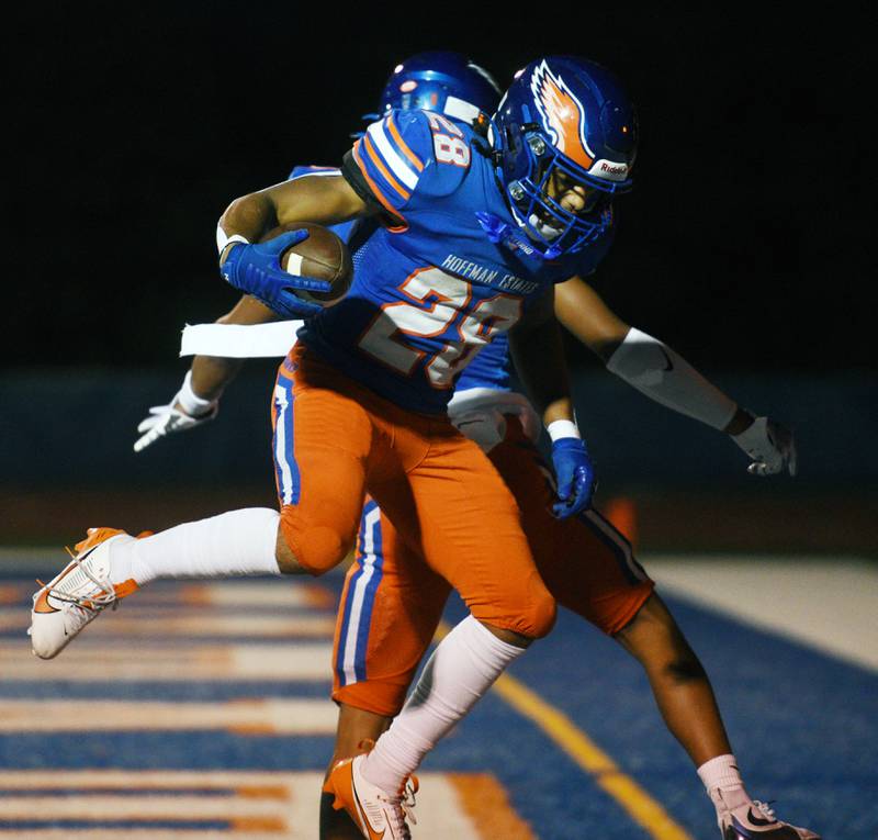 Hoffman Estates’ Landon Ford, front, celebrates a first-quarter touchdown with teammate Jerami Harden during Friday’s football game against Maine East in Hoffman Estates.