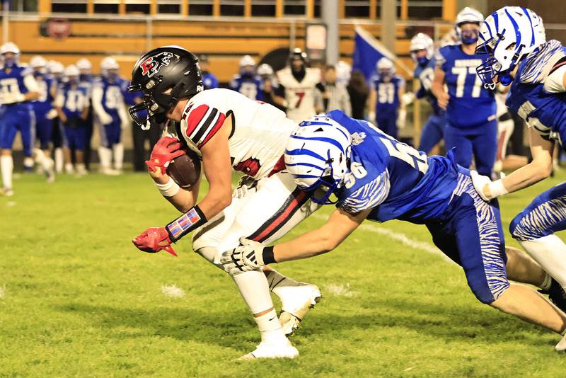 Erie Prophetstown traveled to Princeton Friday to take on the Tigers in the last regular season game. #15 Evan Steimle trying to pick up some yards as #56 Owen Hartman goes in for the tackle.