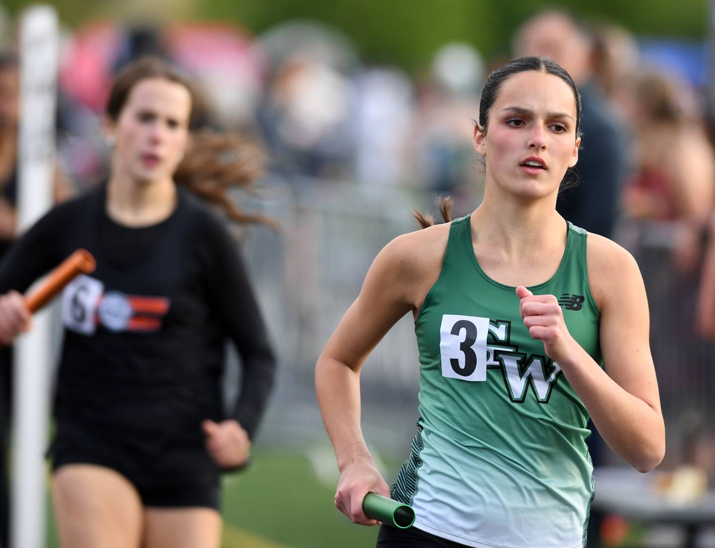 Glenbard West anchor Katie King is less than 400 meters from the finish as the Hilltoppers finish second in the 3,200-meter relay during the 48th annual Tiger Girls Track and Field Invitational at Wheaton Warrenville South High School in Wheaton on Friday, May 1, 2026.