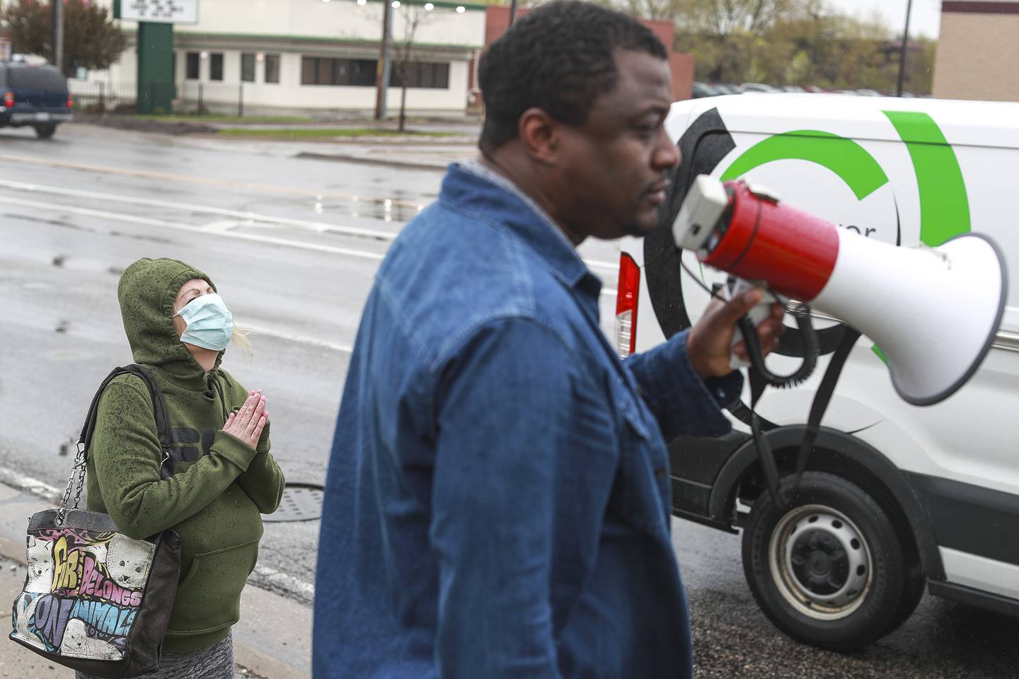 An activists tops to pray on Monday, April 19, 2021, at the intersection of Jefferson St. and Larkin Ave. in Joliet, Ill. Members of Joliet's community of faith came together to raise awareness and call for justice for George Floyd.