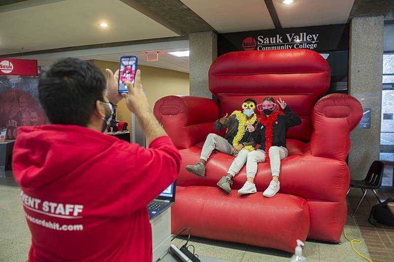 Montez Taylor of Milwaukee and Ainsleigh Hendrix of Rock Falls wave to the camera as Jovani Villa of Maywood takes their picture at Sauk Valley College. The school welcomed students back to class on Tuesday.