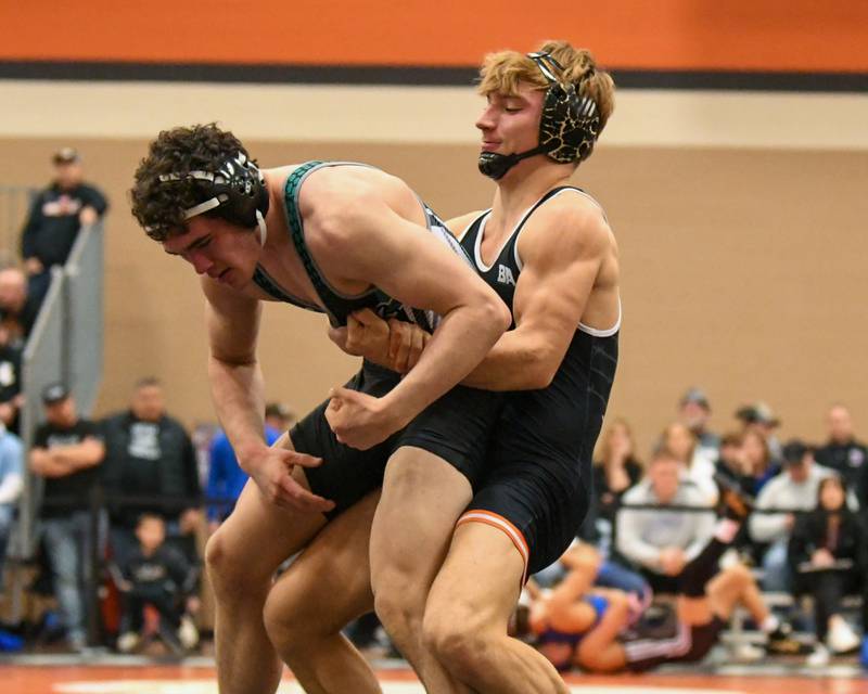 DeKalb wrestler Sean Kolkebeck, right, takes down Danny DeCristofaro of York High School before getting the pin in the first period during the last day of the Flavin invite on Saturday Dec. 30, 2023, held at DeKalb High School.