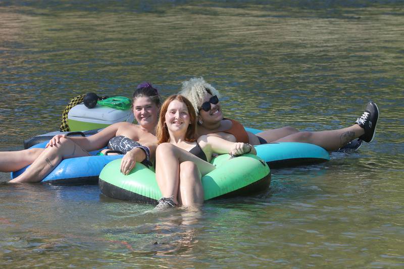 Brea Faux of Peru, Kerri Herman of Spring Valley and Lana Ramsey of Spring Valley cool off on inner tubes on Wednesday, Aug. 23, 2023 in Oglesby.