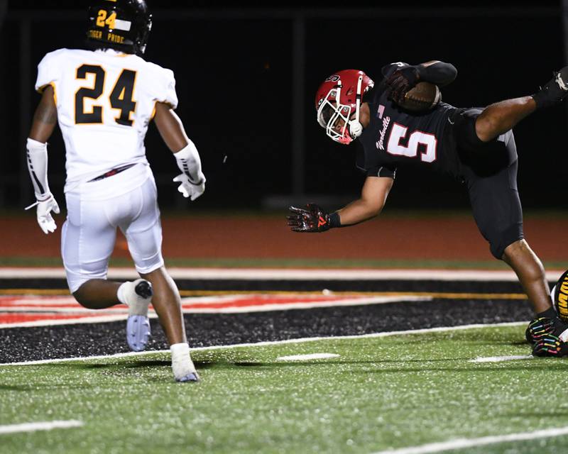 Yorkville's Tavaris Harland (5) dives into the endzone after being tripped up by a Joliet West player during the game on Friday Sept. 5, 2025, held at Yorkville High School.