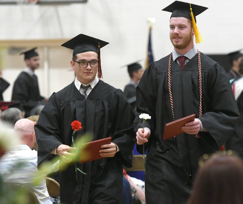 Braydon Altherr and Mason Fox exit the Forreston High School gym following commencement on Sunday. Fifty-five seniors received diplomas during the afternoon event.