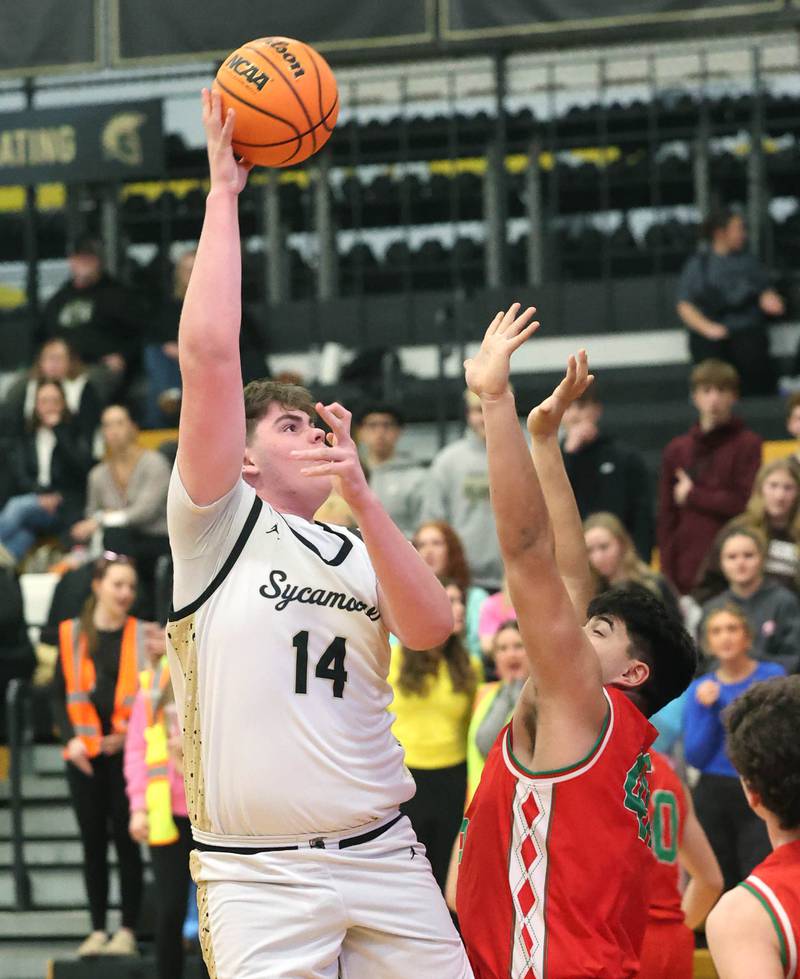 Sycamore's Michael Chami shoots over La Salle-Peru's Andy Medina during their game Tuesday, Feb. 4, 2025, at Sycamore High School.