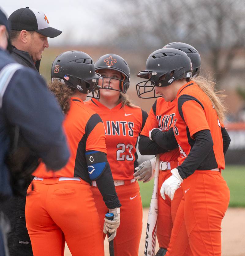 St. Charles East's head coach Jarod Gutesha talks to his players during a break in play against St. Charles North during a softball game at St. Charles East High School on Monday, April 25, 2022.