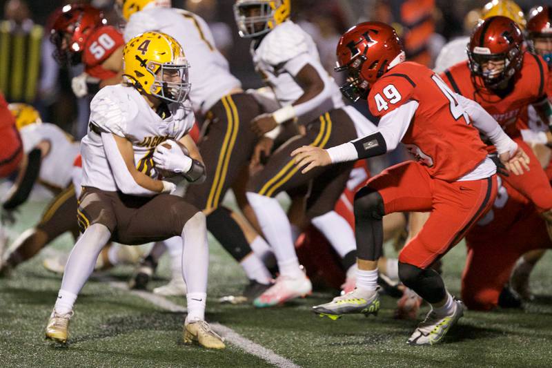 Jacob's Joey Scrivani looks for room to run against Huntley's Ari Fiebig on Friday, Sept. 23,2022 in Huntley.