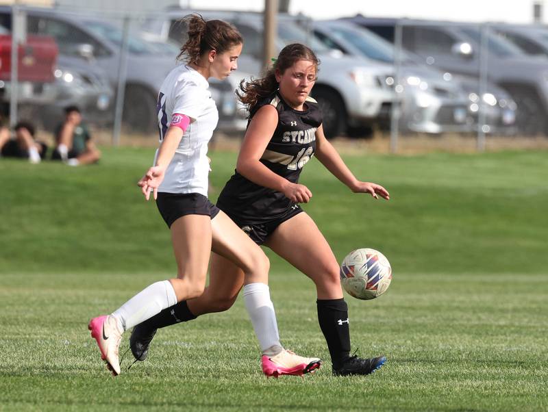 Dixon’s Leah Stees (left) tries to get by Sycamore's Charlotte Yates during their game Thursday May 15, 2025, at Sycamore High School.