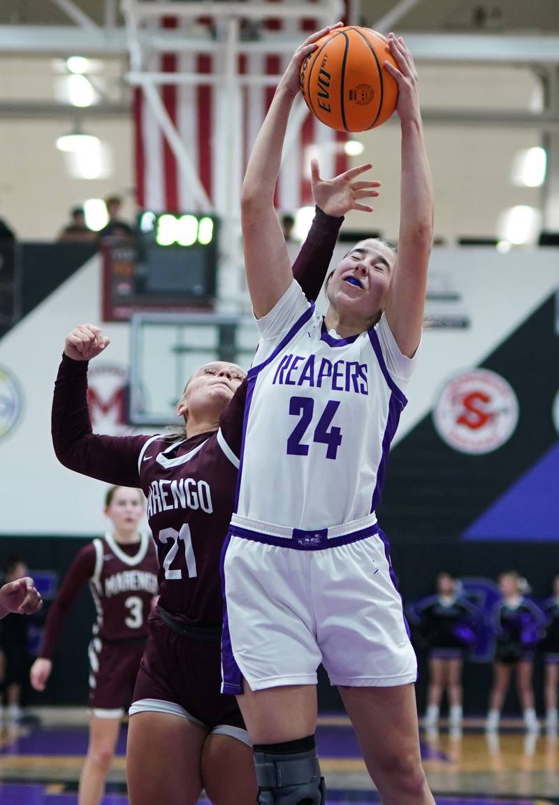 Plano's Chloe Rowe (24) rebounds the ball against Marengo’s Mia Feidt (21) during a basketball game at Plano High School on Wednesday, January 29, 2025.