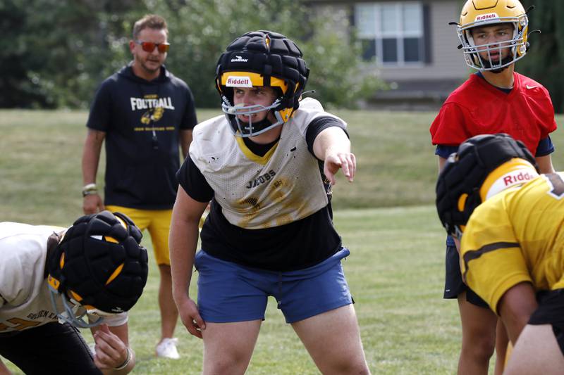 Jacobs’ Lucas Retzler calls out blocking assignments during football practice on Tuesday, August 15, 2025, at Jacobs High School in Algonquin.